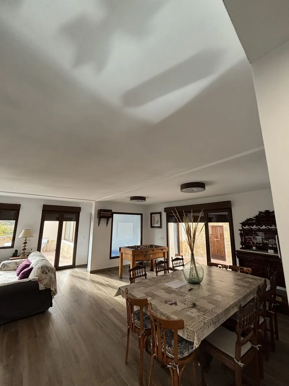 Zona de comedor y sofá del salón principal de la casa rural